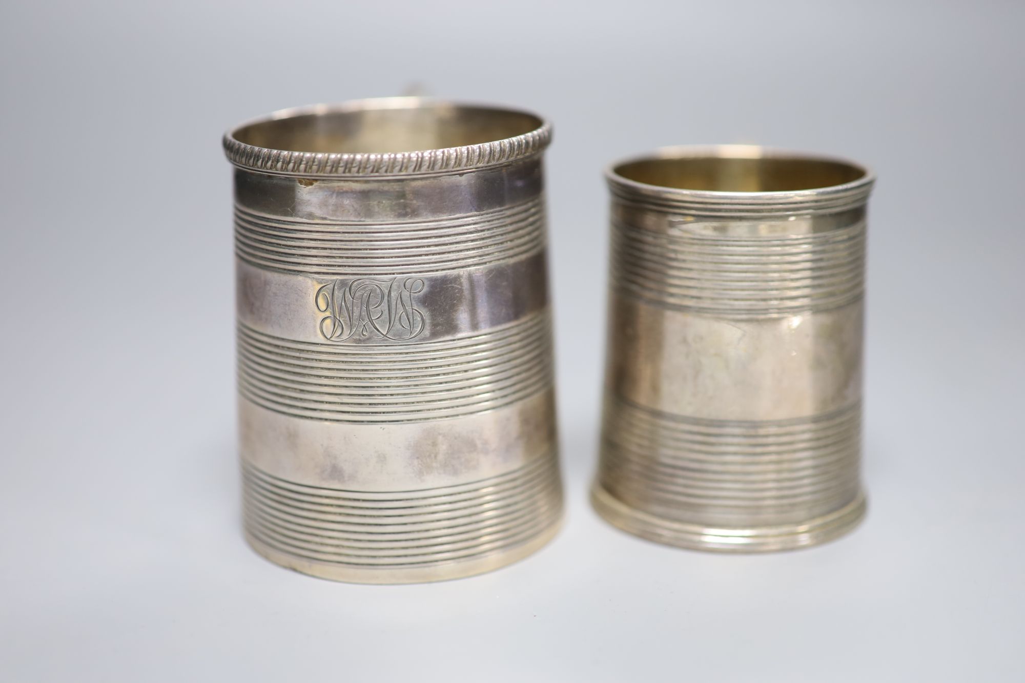 A George III reeded silver christening mug, London, 1812 and one other later mug, London, 1827,